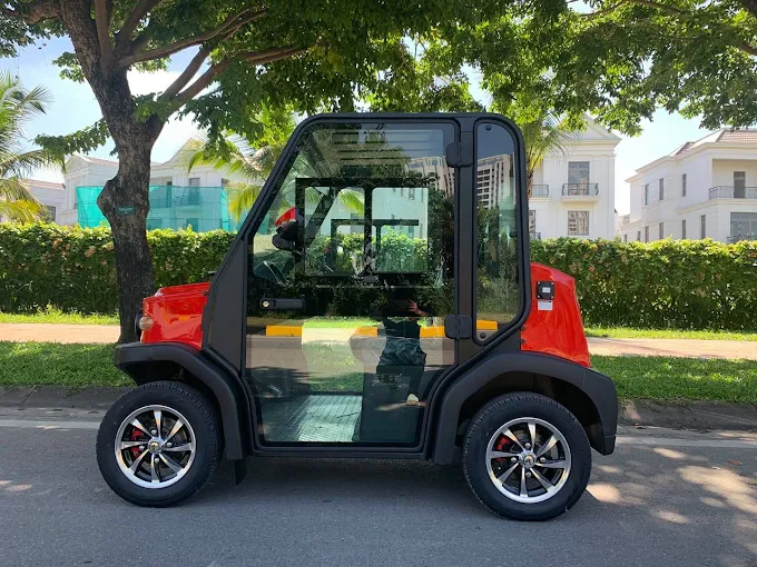 Red ANC golf cart, side view