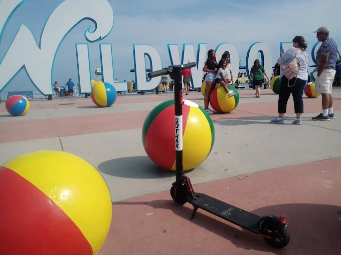 Electric scooter at the Wildwoods sign